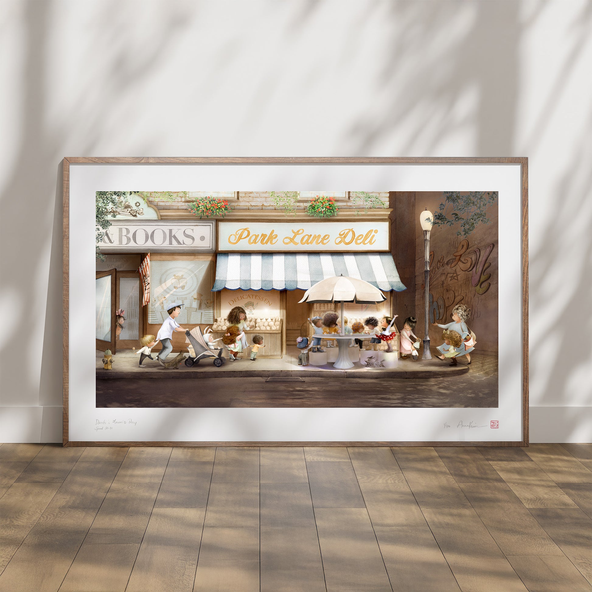 Framed artwork of a street scene with people and shops on a wall.