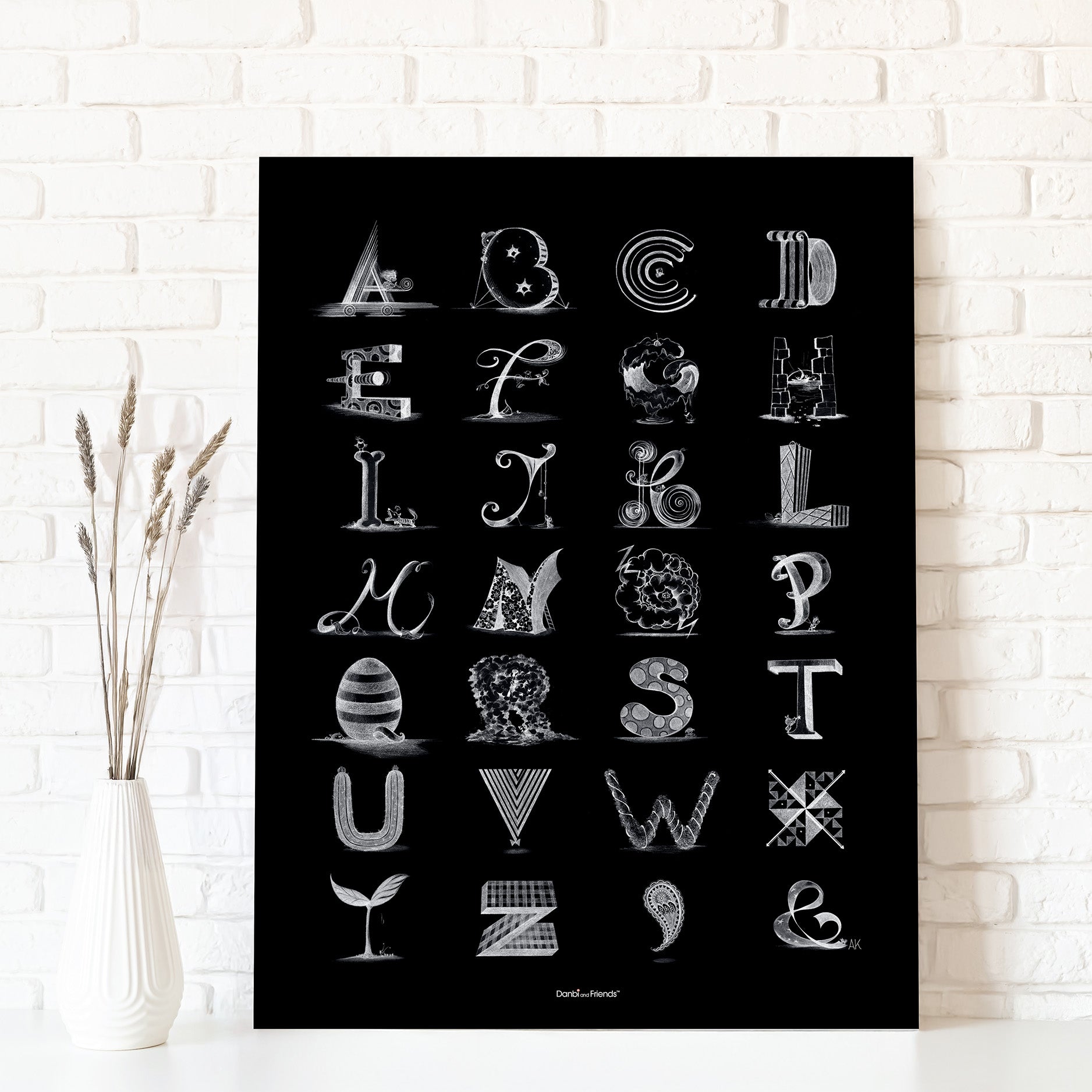 Black poster with white alphabet letters on a white brick wall background