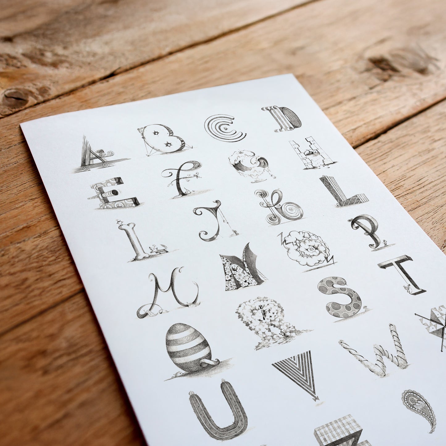 Sheet of decorative letters on a wooden surface