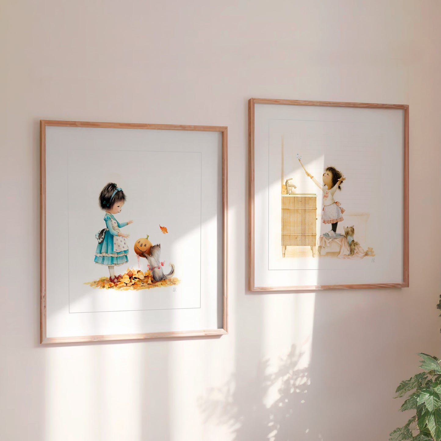 Two framed illustrations of Danbi with her pets