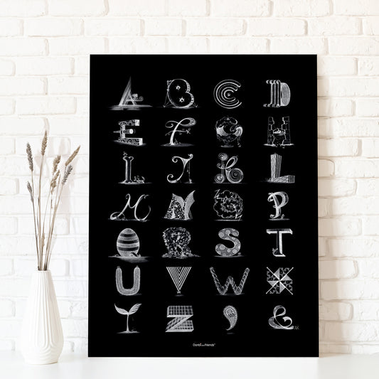 Black poster with white alphabet letters on a white brick wall background