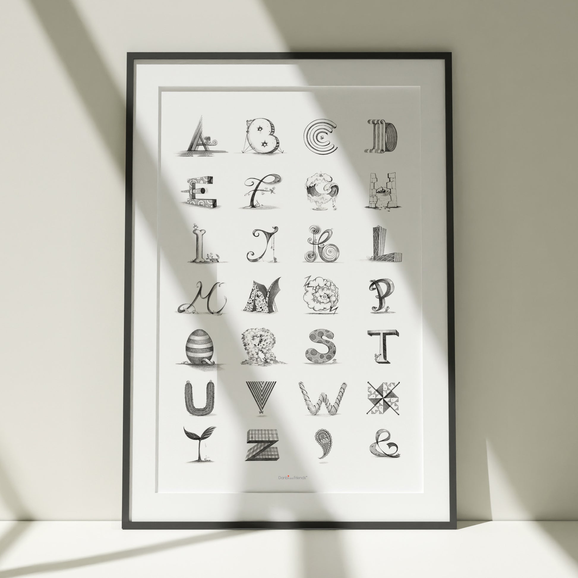 Framed alphabet poster with decorative letters on a light background