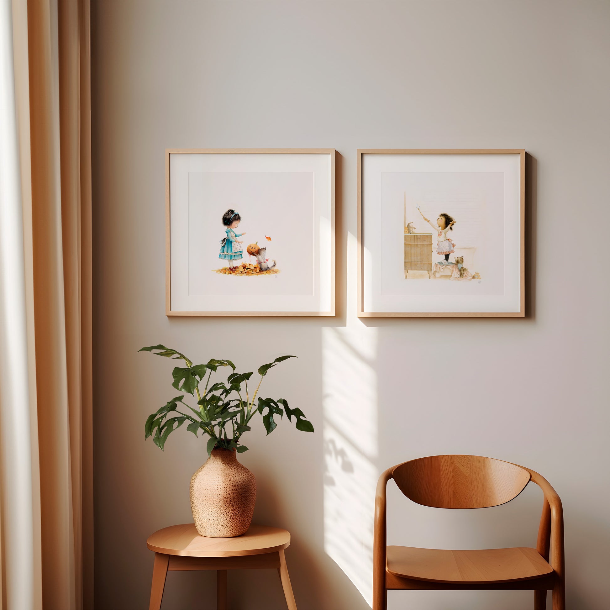 Two framed artworks of Danbi and her pets on a wall with a plant and chair in the foreground.